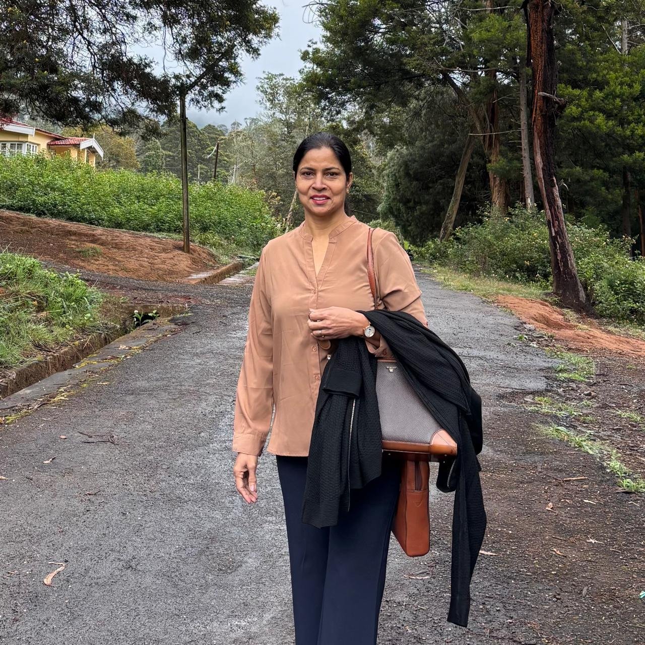 Rajwant Kaur outdoors on a tree-lined path