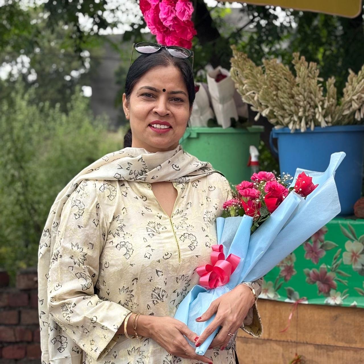 Rajwant Kaur holding a bouquet outdoors